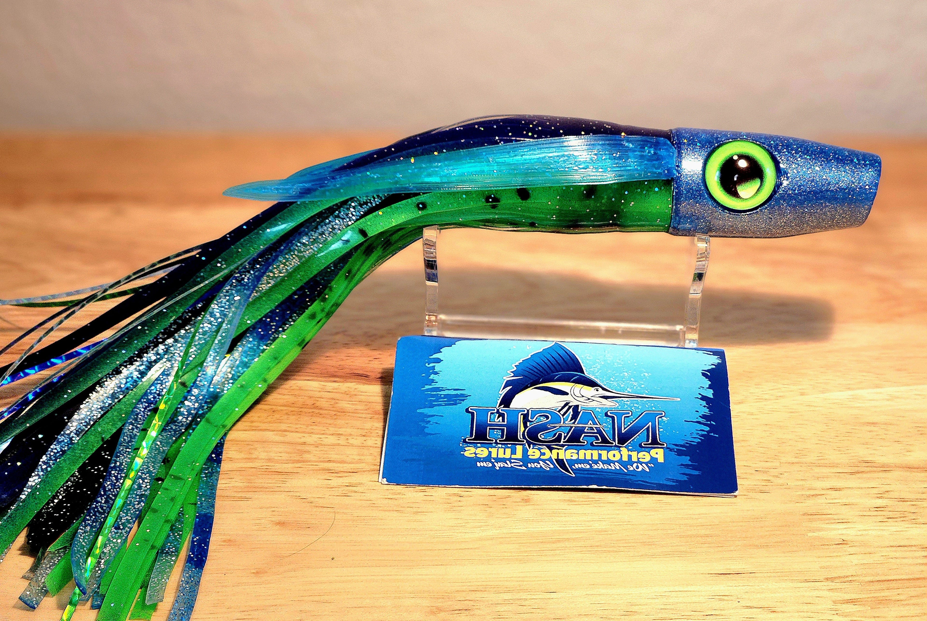 Colorful fishing lure with a Nash Performance Lures card on a wooden surface